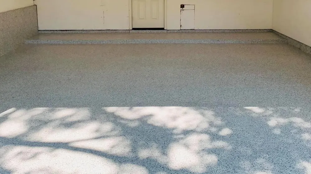 Gray flake epoxy garage floor with coated step